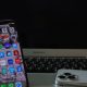 Notebook aberto ao lado de um smartphone sobre uma mesa, representando produtividade e conectividade entre dispositivos.